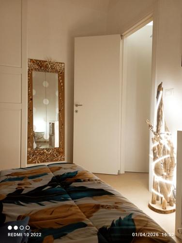 a bedroom with a bed and a mirror at ALMAREDo in Bisceglie
