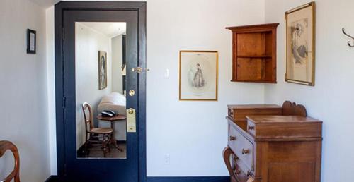 a room with a door and a table and a chair at The Little Inn in Bayfield
