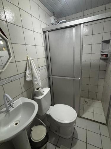 a bathroom with a shower and a toilet and a sink at Suítes Marrakesh in Porto De Galinhas