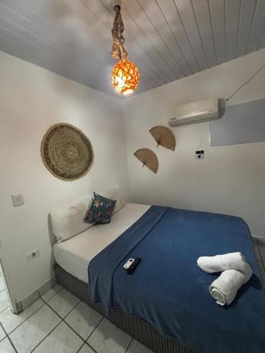 a bedroom with a bed with umbrellas on the wall at Suítes Marrakesh in Porto De Galinhas
