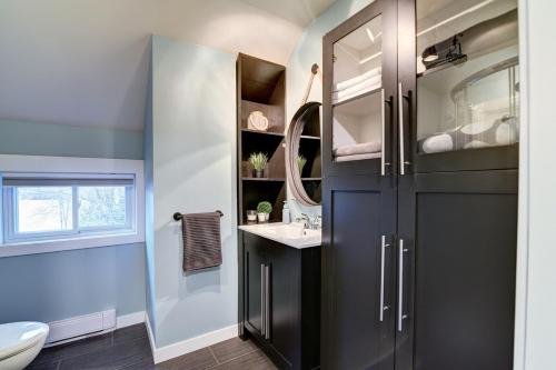 a bathroom with a black cabinet and a sink at Lake Joseph Retreat -Waterfront and Hot tub in Saint-Pierre-Baptiste