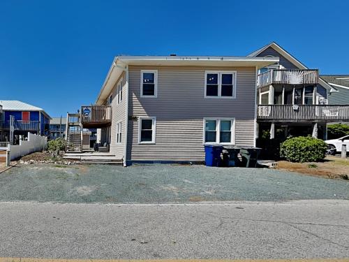 a large house with a driveway in front of it at Sea Glass Suites 2 in Topsail Beach