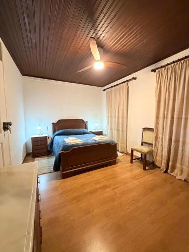 a bedroom with a bed and a wooden ceiling at Casa da Praça de Murça in Murça