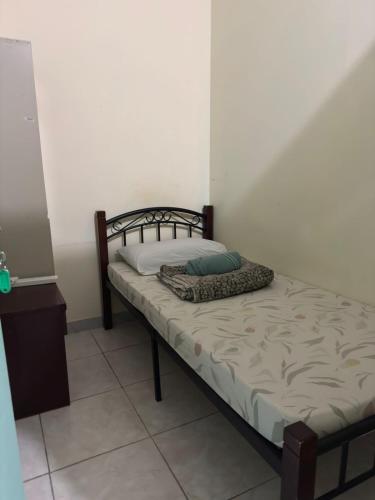 a small bed in a room with at Backpacker's Bed - No Parking in Abu Dhabi