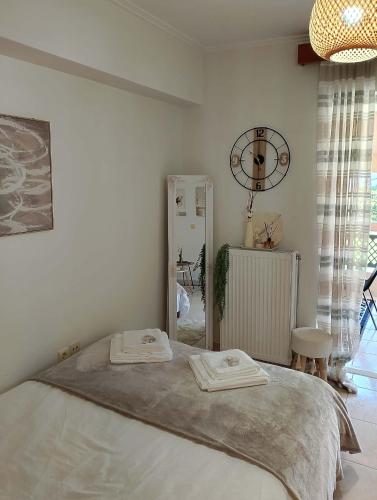 a bedroom with a bed with two towels on it at ΚΝΗΜΙΣ Apartment in Agios Konstantinos