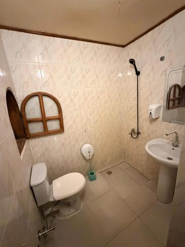 a bathroom with a toilet and a sink at Ghazala hotel dahab in Dahab