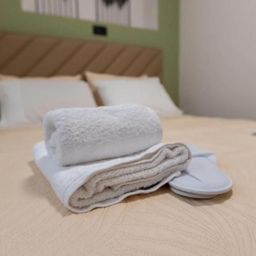 a pile of towels sitting on top of a bed at Thalori Home Georgioupolis in Georgioupolis