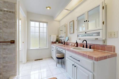 a kitchen with white cabinets and a sink and a window at 'Whispering Oaks Estate' w/ Pool & View in Murphys in Vallecito