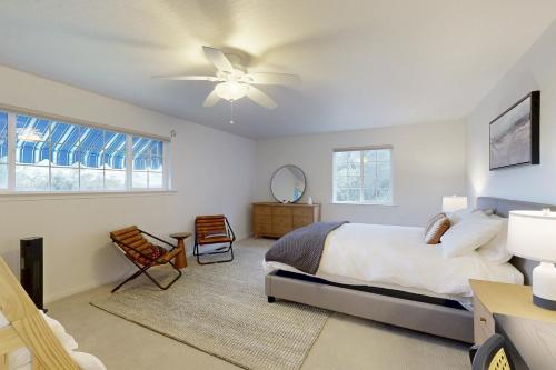 a bedroom with a bed and a ceiling fan at 'Whispering Oaks Estate' w/ Pool & View in Murphys in Vallecito