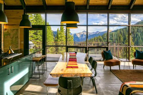 a dining room with a table and a view of mountains at Campfire Ranch Private Cabin, Meals Included in Bergen Park