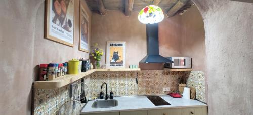 a kitchen with a sink and a stove at Casa Doval in Cortelazor