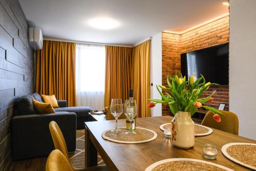 a living room with a table with wine glasses at Libertè suites Velingrad in Velingrad