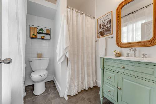 a bathroom with a toilet and a sink and a mirror at NIGHTCAP @ Speakeasy Inn Key West! in Key West