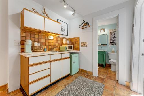 a kitchen with a sink and a toilet at BOOTLEGGER BAY @ Speakeasy Inn Key West! in Key West