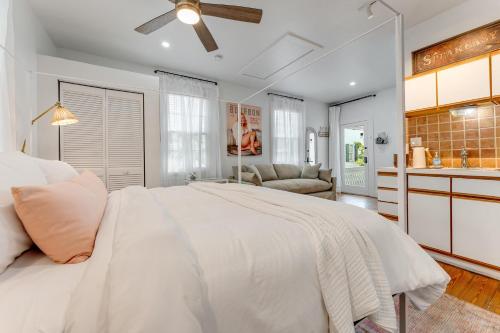 a white bedroom with a large bed and a kitchen at AFTER HOURS @ Speakeasy Inn Key West! in Key West
