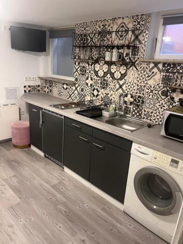 a kitchen with a sink and a washing machine at ZK Zimmer in Stuttgart