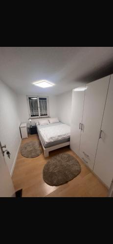 a bedroom with a bed and two rugs in it at ZK Zimmer in Stuttgart