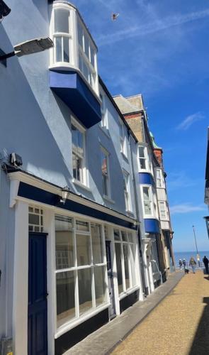 a blue and white building on a street next to the ocean at Beachway, Cromer in Cromer
