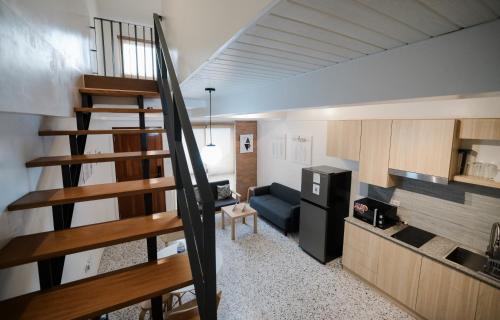 a small room with a staircase leading to a kitchen at Casita Benito Loft D in Sangley Point Naval Station