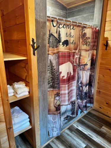 a quilt hanging on a door in a cabin at Creekside Blessings Cabin in Beech Mountain