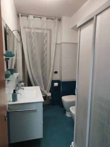 a bathroom with a sink and a toilet and a shower at Sweet Home in Oliveri