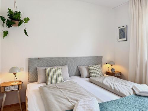a bedroom with a large bed and aarijuanaarijuana at Ferienwohnung Im schönen Dorf - idyllische Lage mit Terrasse und Garten in Lindau-Bodolz