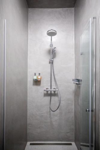 a shower with a shower head in a bathroom at Residence 1892 - Apartment 3 in Bratislava