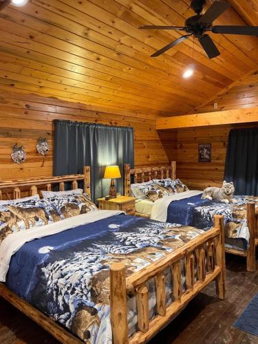 a bedroom with two beds in a log cabin at Bear creek resort in Thompson Falls
