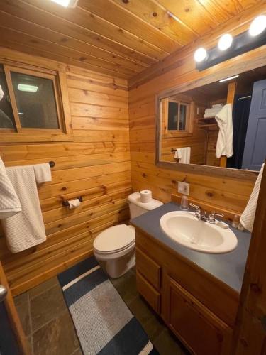 a wooden bathroom with a sink and a toilet at Bear creek resort in Thompson Falls