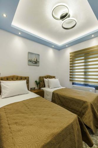 a bedroom with two beds and a ceiling at The Hidden Gem Skopelos - Elegant Island Retreat in Skopelos Town