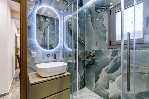 a bathroom with a sink and a shower at The Hidden Gem Skopelos - Elegant Island Retreat in Skopelos Town