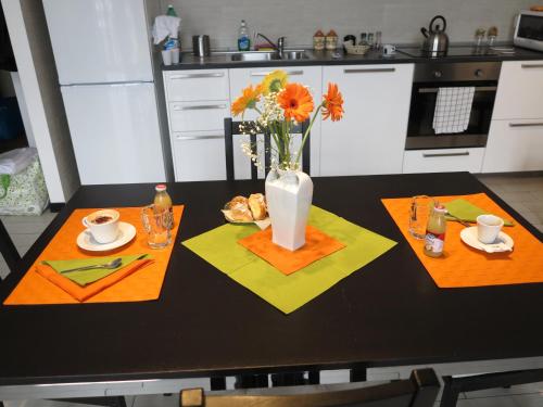 una mesa de cocina con un jarrón de flores. en SweetHomeToledo, en Nápoles