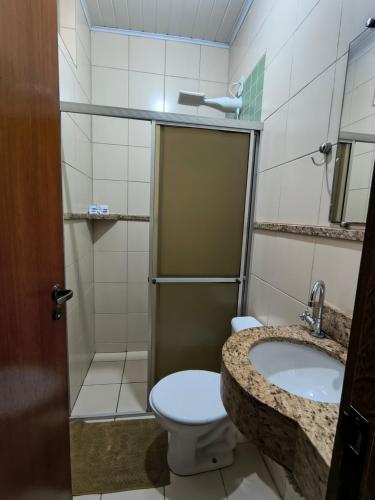 a bathroom with a toilet and a sink at Hotel do Porto in Porto Velho