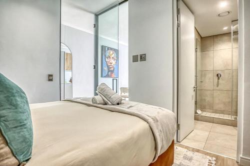 a bedroom with a large bed and a shower at Caica Executives at Ellipse 4103 in Midrand