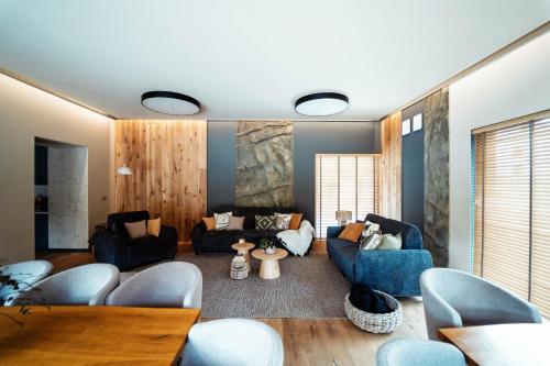 a living room with couches and a table at Leśniczanka in Brenna
