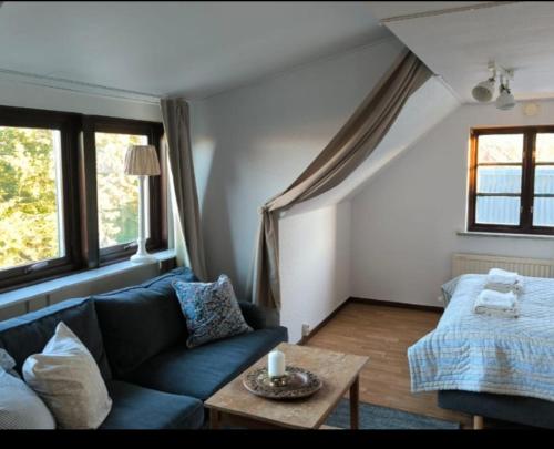 a living room with a couch and a table at Lilla lugnet in Ystad