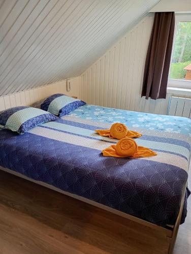 a bed with two towels on top of it at Family Bungalow De Strandjutter 8 people in Middelkerke