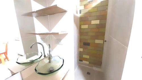 a bathroom with a sink in a room at Hostal SAVEVA in Medellín