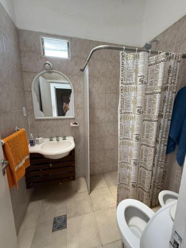 a bathroom with a shower and a sink and a toilet at La Casa de Alicia in Chivilcoy