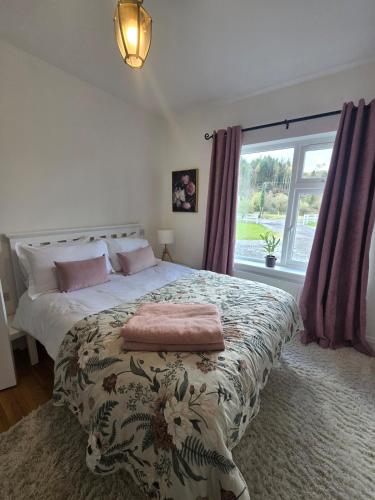 a bedroom with a large bed and a window at The Bungalow Killybegs in Killybegs