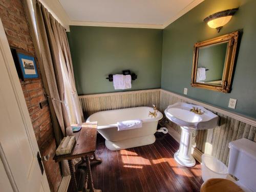 a bathroom with a white tub and a sink at Iron Horse Hotel in Blackwater