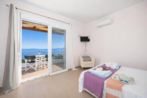 a bedroom with a bed and a view of the ocean at Villa Alya View in Barbati
