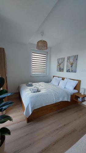 a bedroom with a bed and a window at Apt 415 Svit in Jezersko