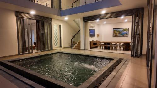 a swimming pool in the middle of a house at Zenna villa long Hải in Bà Rịa