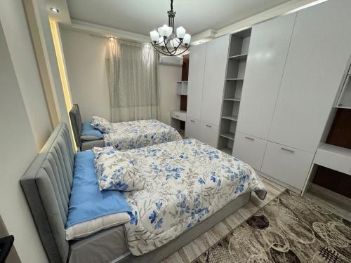 a bedroom with two beds and a closet at Cabilyt Cairo Luxiury Apartment in Obour