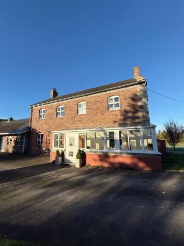 a large brick building with a lot of windows at Castle Oliver Farm in Ardpatrick