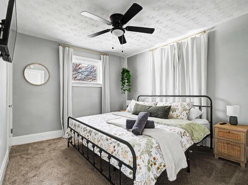 a bedroom with a bed with a ceiling fan at Newly Renovated and Designed Near Downtown in Cleveland