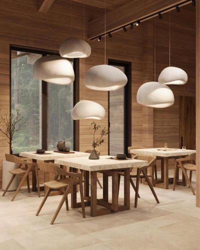 a dining room with tables and white pendant lights at Anima Resort Aghveran - Forest Retreat in Aghveran