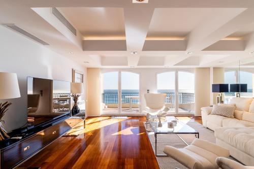 a living room with a couch and a television at Cascais Lux - New Apartment in Parede