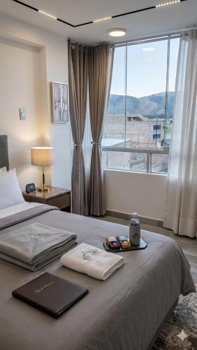 a bedroom with a bed with a large window at Hostal New York in Jauja